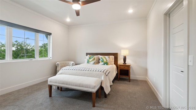 carpeted bedroom with ceiling fan and crown molding