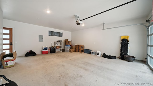 garage featuring electric panel and a garage door opener