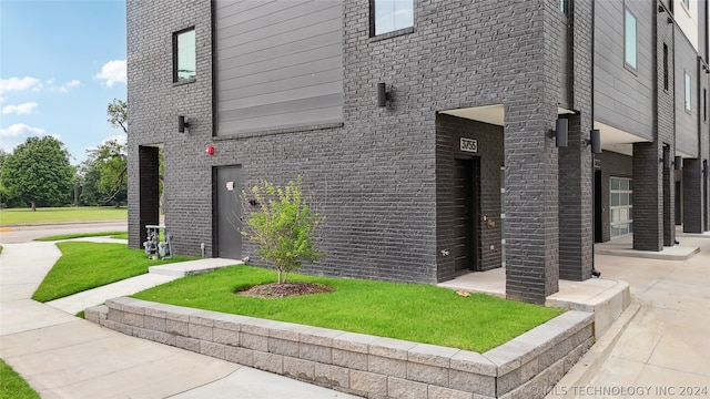 view of side of home featuring a lawn