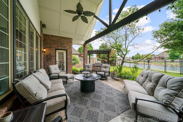 view of patio / terrace featuring an outdoor living space, a water view, and ceiling fan