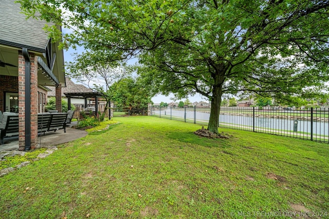 view of yard with a patio and a water view