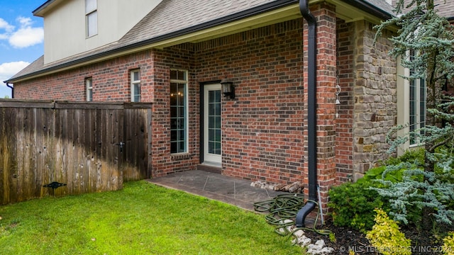 view of side of property with a yard and a patio area