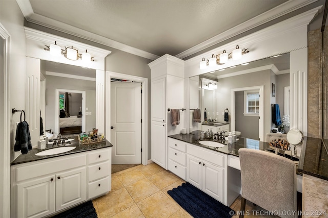 bathroom with vanity, crown molding, and tile patterned flooring