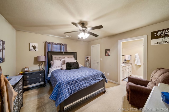 bedroom featuring connected bathroom, ceiling fan, a textured ceiling, and carpet floors