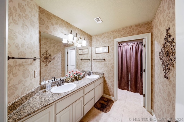 bathroom featuring vanity, a textured ceiling, and tile patterned flooring