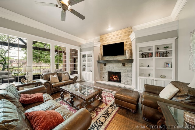 living room featuring crown molding, hardwood / wood-style floors, and a fireplace