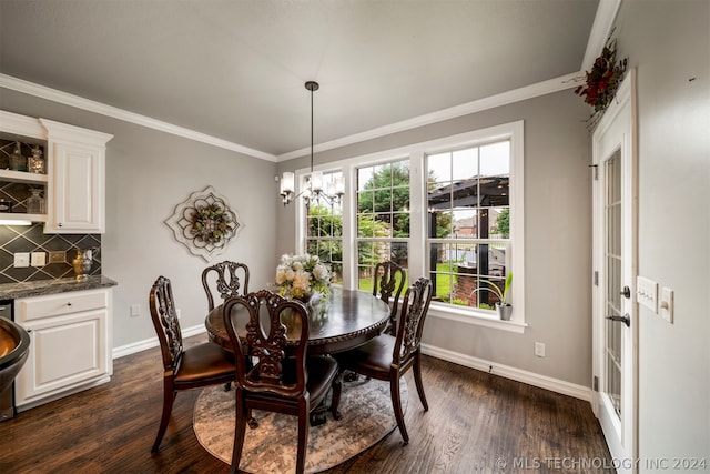 dining space featuring crown molding, a chandelier, and dark hardwood / wood-style floors