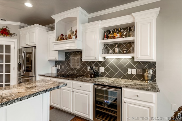 bar featuring white cabinetry, stainless steel refrigerator with ice dispenser, dark stone counters, and beverage cooler