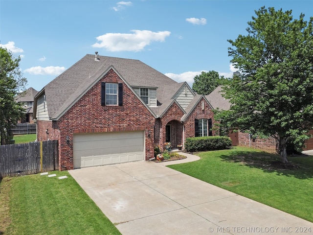 view of front of house with a front lawn and a garage