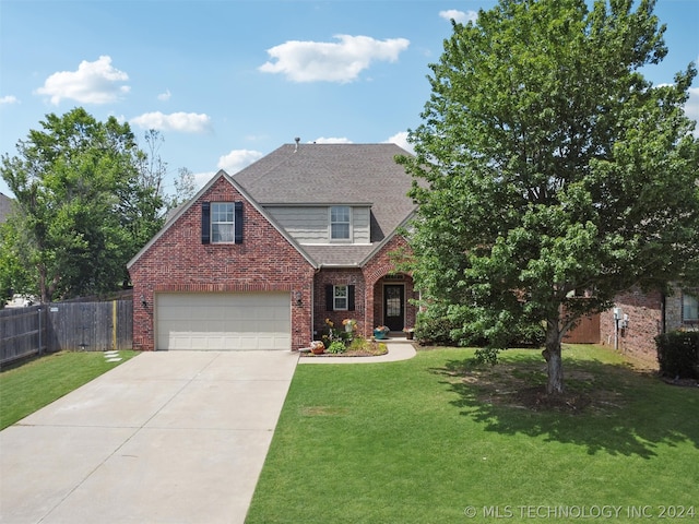 view of front of house with a garage and a front lawn