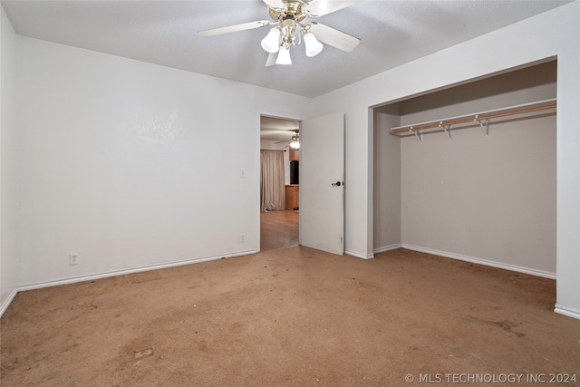 unfurnished bedroom featuring carpet, ceiling fan, and a closet