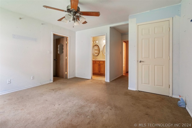 unfurnished bedroom featuring ensuite bathroom, ceiling fan, and carpet floors