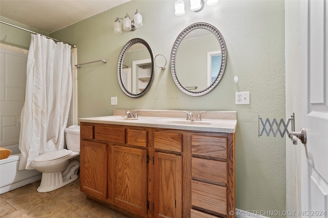 bathroom featuring double vanity, tile flooring, and toilet