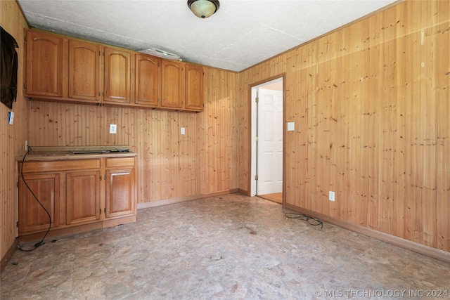 kitchen featuring wooden walls and light tile floors