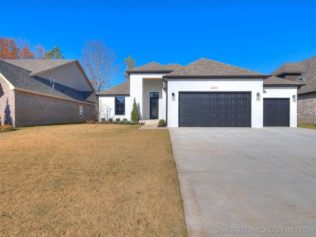 view of front facade with a front lawn and a garage