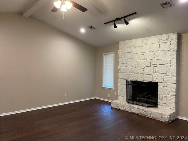 unfurnished living room featuring rail lighting, vaulted ceiling with beams, dark hardwood / wood-style floors, ceiling fan, and a fireplace