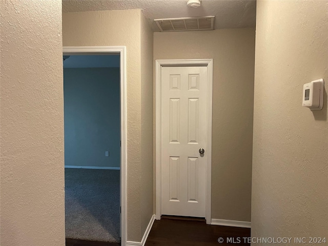 hall with a textured ceiling