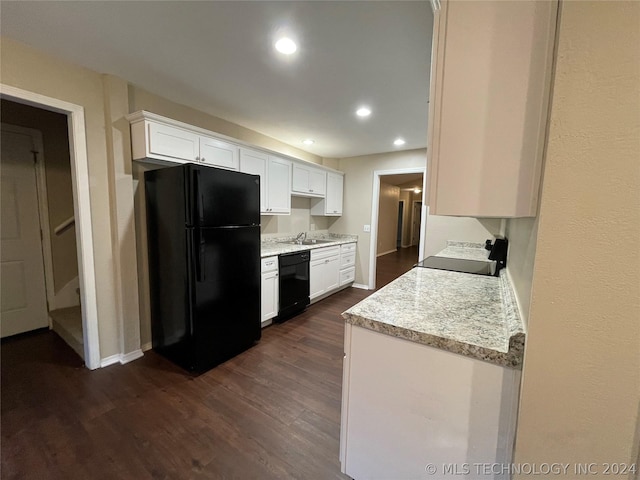 kitchen featuring dark hardwood / wood-style flooring, white cabinets, black appliances, and sink