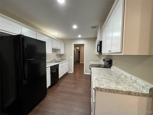 kitchen with black appliances, dark hardwood / wood-style flooring, and white cabinetry