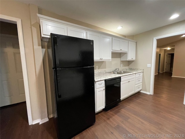 kitchen featuring white cabinetry, sink, light stone counters, dark hardwood / wood-style flooring, and black appliances