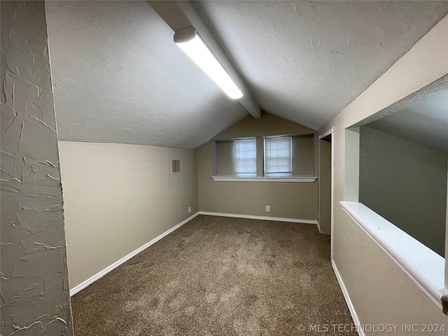 bonus room featuring a textured ceiling, carpet floors, and lofted ceiling