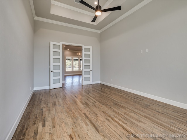 spare room featuring crown molding, french doors, ceiling fan, and light hardwood / wood-style floors