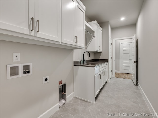 laundry area with cabinets, sink, washer hookup, light tile patterned floors, and hookup for an electric dryer