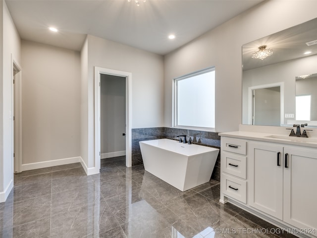 bathroom with a bath and vanity