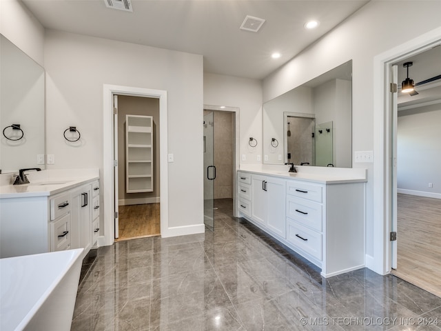 bathroom with vanity, wood-type flooring, and shower with separate bathtub