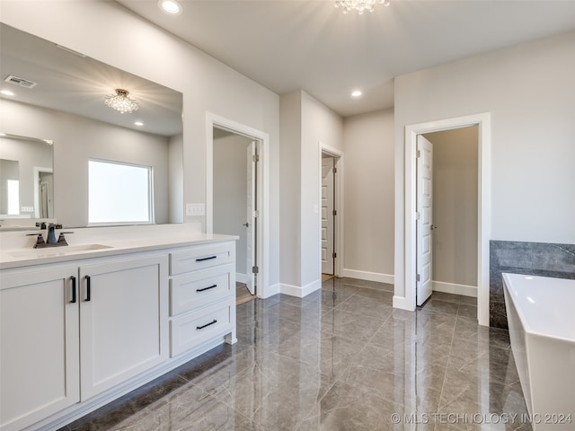 bathroom featuring a washtub and vanity