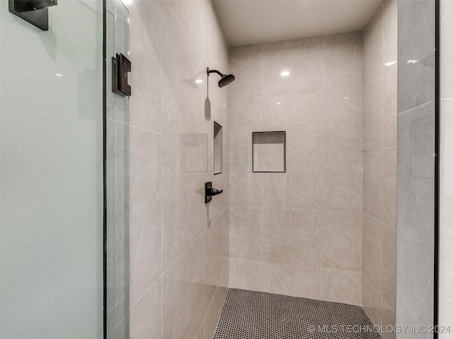 bathroom with a shower with shower door