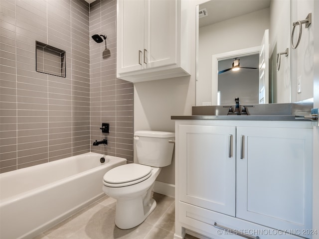 full bathroom featuring tile patterned flooring, vanity, tiled shower / bath combo, and toilet