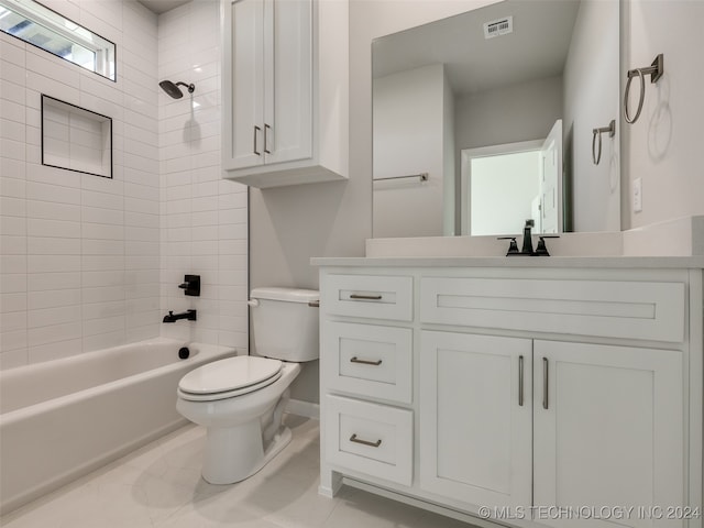 full bathroom featuring vanity, tiled shower / bath combo, and toilet