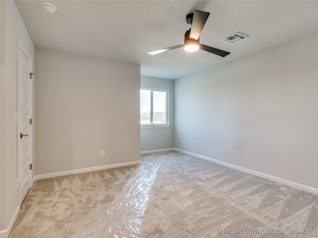 unfurnished room with ceiling fan and light colored carpet