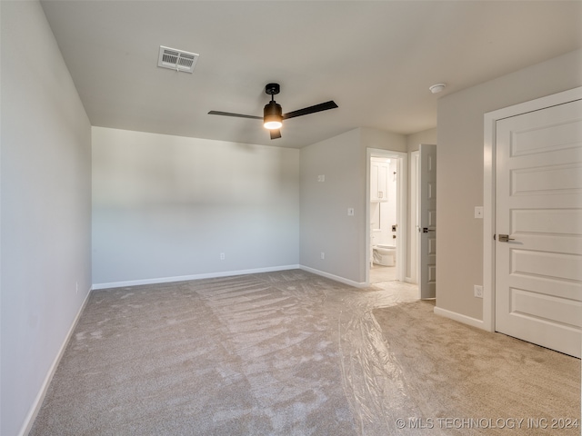 unfurnished room with ceiling fan and light colored carpet