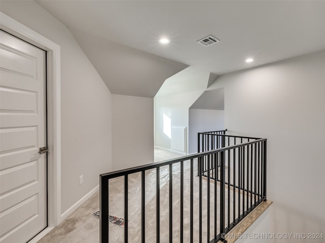 hallway with light colored carpet