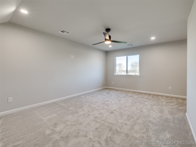 carpeted empty room featuring ceiling fan and vaulted ceiling