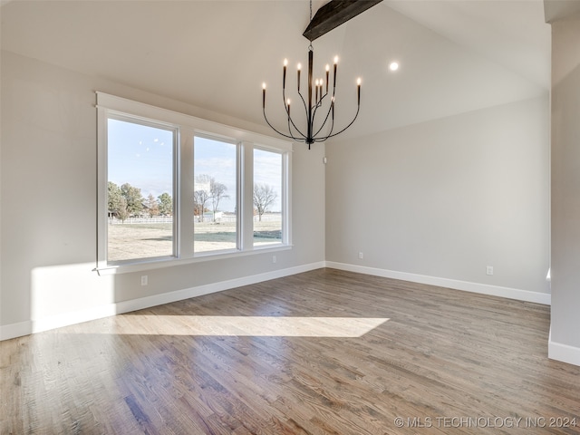 unfurnished dining area featuring vaulted ceiling with beams, hardwood / wood-style floors, and a chandelier