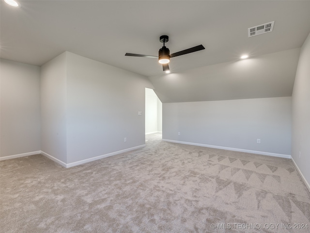 additional living space with ceiling fan, light carpet, and vaulted ceiling