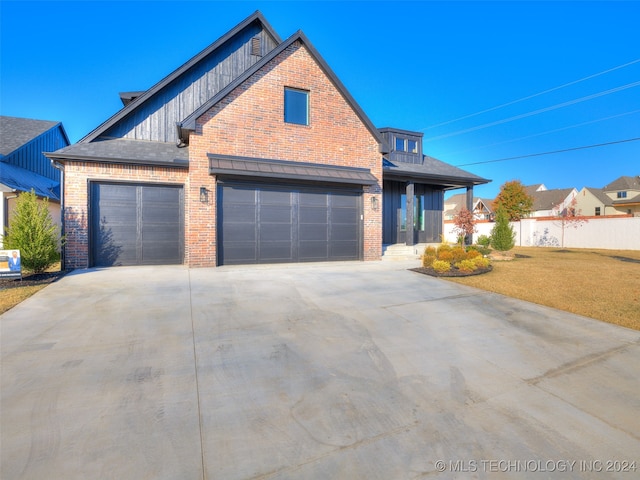 view of front of house with a garage and a front yard