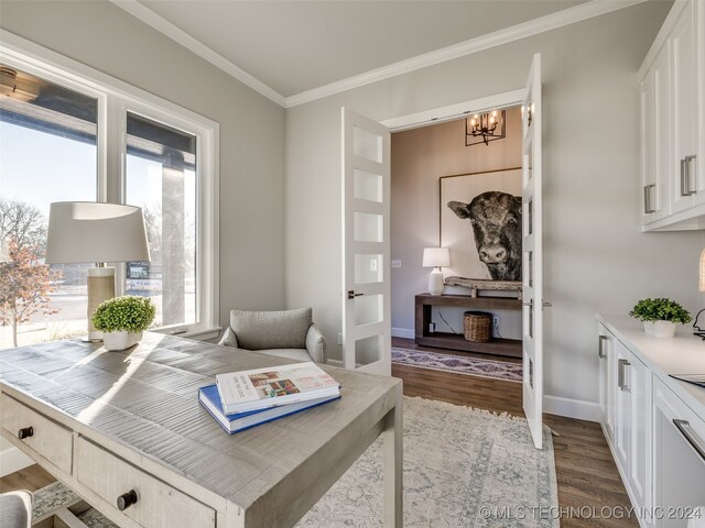 sitting room with a chandelier, dark hardwood / wood-style floors, and ornamental molding