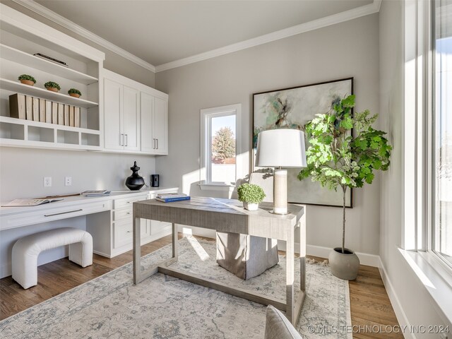 home office with dark hardwood / wood-style flooring and crown molding