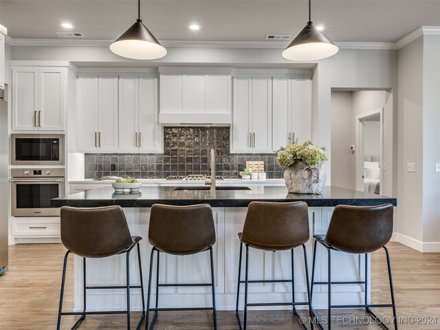 kitchen with white cabinets, oven, and black microwave