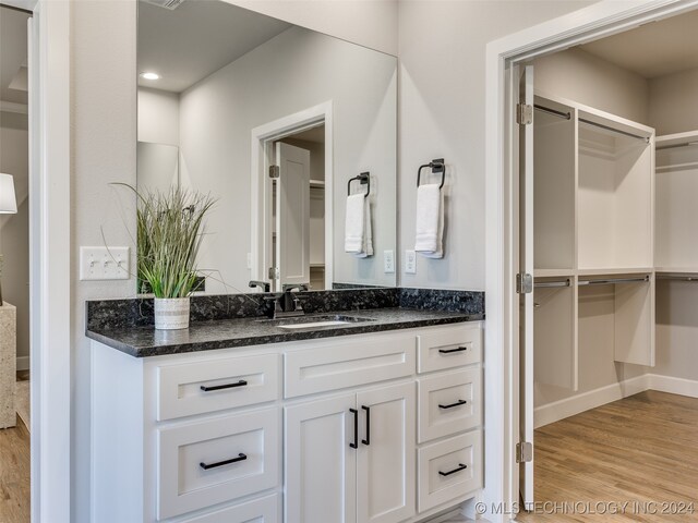 bathroom featuring vanity and wood-type flooring