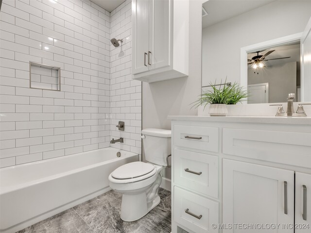 full bathroom with vanity, ceiling fan, toilet, and tiled shower / bath