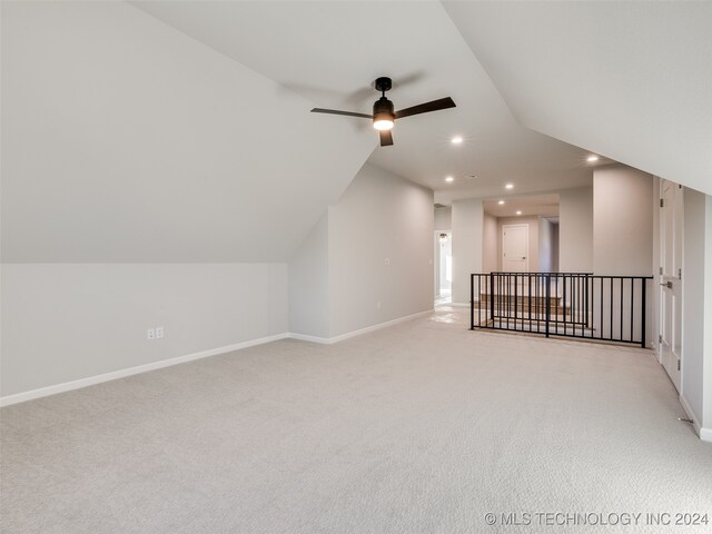 bonus room with ceiling fan, light colored carpet, and vaulted ceiling