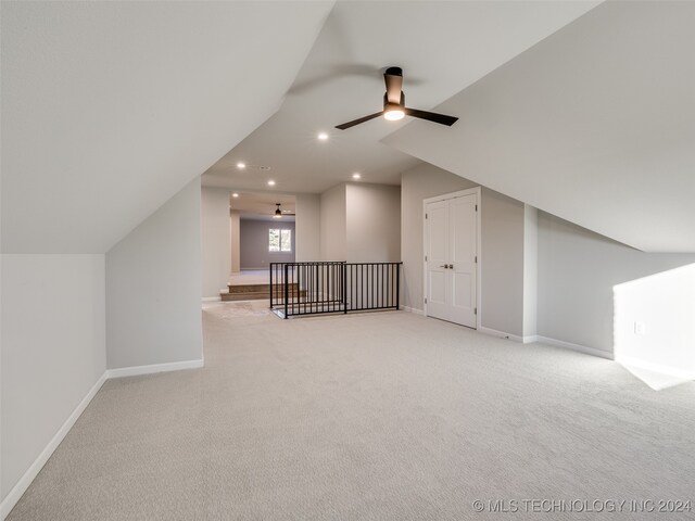 bonus room with light carpet, vaulted ceiling, and ceiling fan