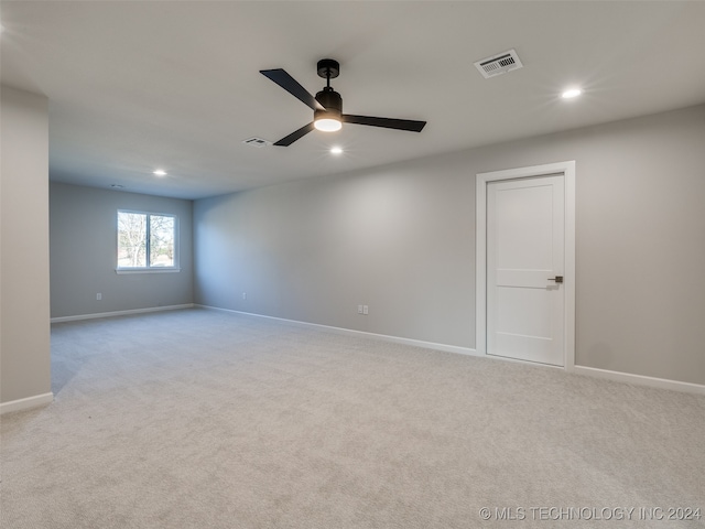 carpeted spare room with ceiling fan