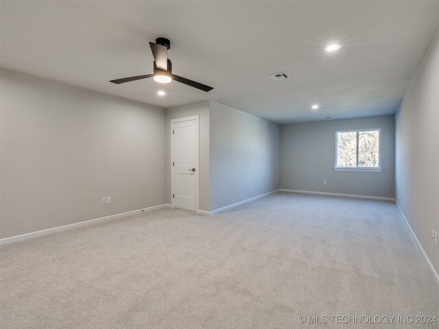 spare room with light carpet and ceiling fan