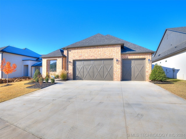 view of front of house with a garage and a front yard